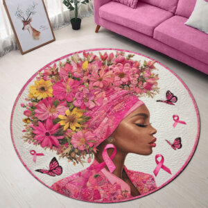 Round breast cancer rug featuring vibrant pink flowers and ribbons, viewed from above.