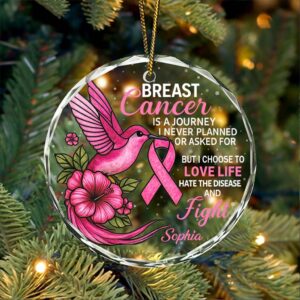 Front view of a personalized breast cancer ornament with a pink bird and floral design, sparkles in the background.