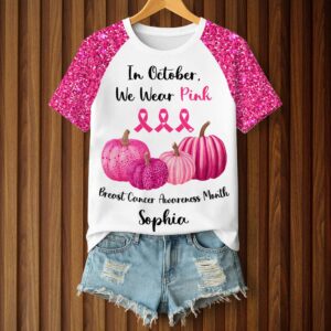 Front view of a custom breast cancer awareness t-shirt featuring pink pumpkins and sparkly sleeves.