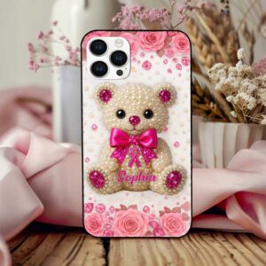 Close-up view of a custom breast cancer awareness phone case with a cute teddy bear and pink roses.