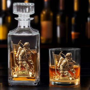 Personalized firefighter whiskey glass with a gold firefighter design, viewed from the front.