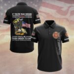 Front view of the black polo shirt with 'If You're Man Enough' design and firefighter emblem on the sleeve.