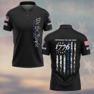 Front view of the defending the line polo, black with blue text and flag detail on sleeves.