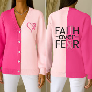 Front view of a breast cancer knitted cardigan in pink with heart and ribbon details.