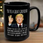 Close-up of the you're a great girlfriend mug showcasing the vibrant design and black color against a wooden table.