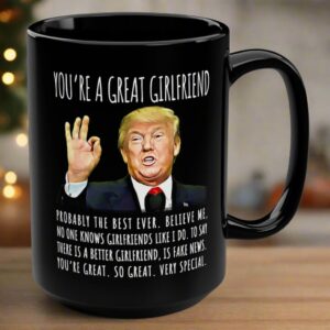 Close-up of the you're a great girlfriend mug showcasing the vibrant design and black color against a wooden table.