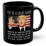 Front view of the black you're a great father mug featuring a humorous design and bold text.