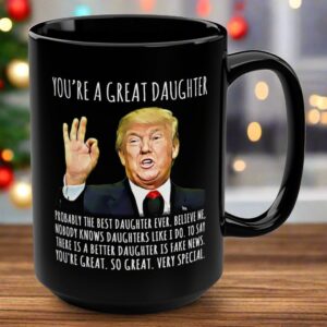 Front view of the black mug featuring 'you're a great daughter' text and a Trump illustration.