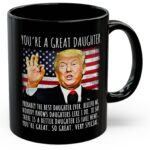 Front view of the you're a great daughter mug showcasing a colorful design against a black background.