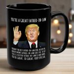 Close-up view of the black mug featuring 'you're a great father-in-law mug' text and design details.