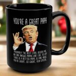 Front view of the you're a great papa mug, black ceramic with humorous Trump design and bold text.