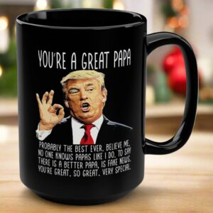 Front view of the you're a great papa mug, black ceramic with humorous Trump design and bold text.