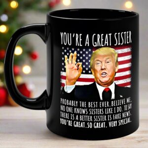 Close-up of the you're a great sister mug featuring a black finish and vibrant Trump design against a flag backdrop.