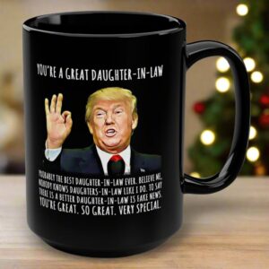 Front view of the you're a great daughter-in-law mug showcasing the design in black with humorous text and Trump image.
