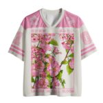 Front view of the sakura in full bloom mesh jersey showcasing vibrant pink floral designs and sporty cut.