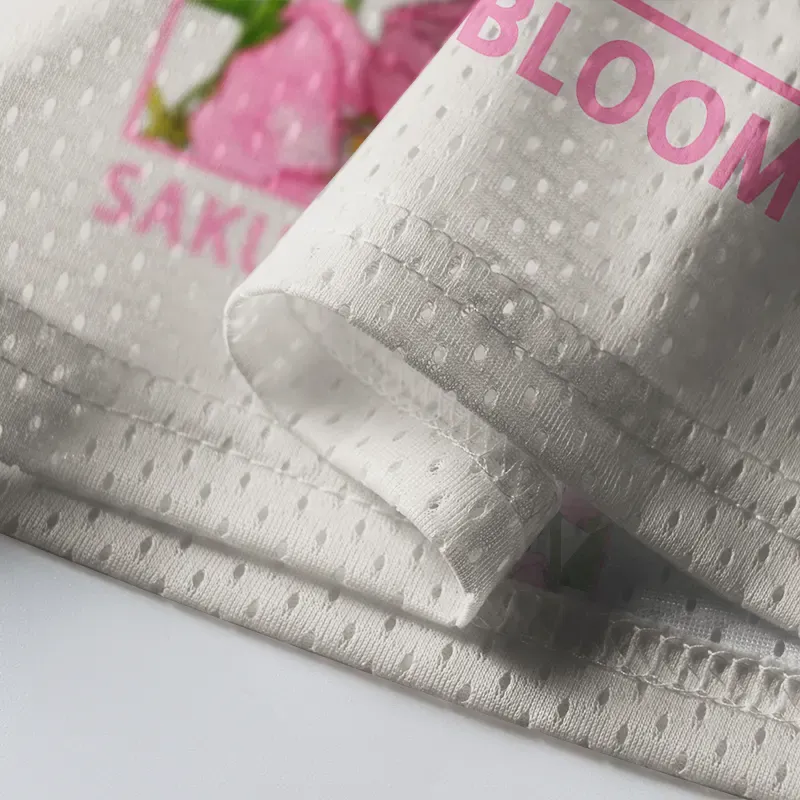 Sakura In Full Bloom Mesh Jersey Close-up of the sakura in full bloom mesh jersey highlighting intricate floral patterns and breathable fabric texture.