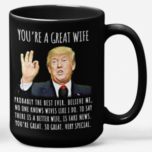 Front view of the black 15oz you're a great wife mug with humorous Trump quote design.