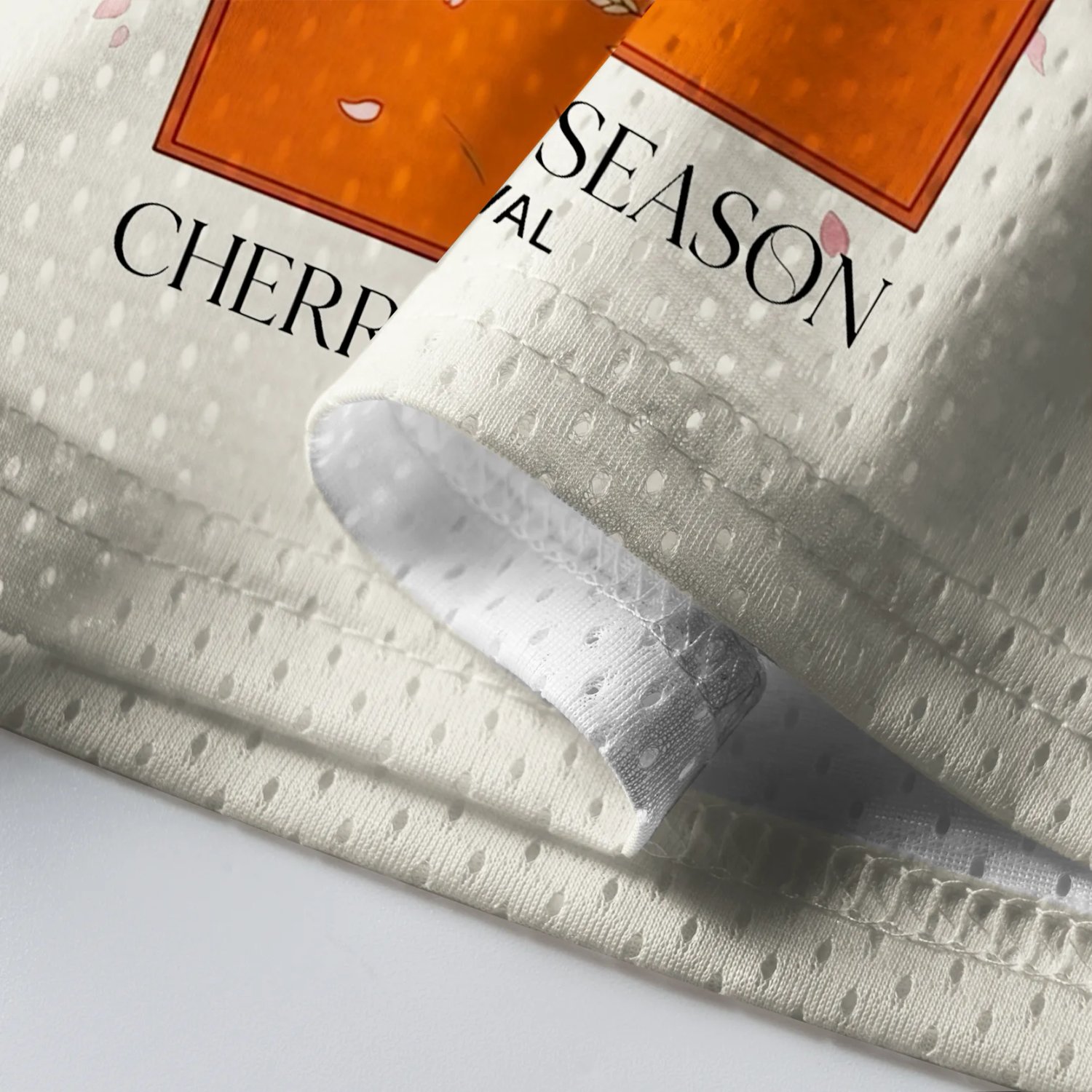 Nago Cherry Blossom Mesh Jersey Detail shot of the Nago Cherry Blossom Mesh Jersey highlighting the intricate cherry blossom print and mesh texture.