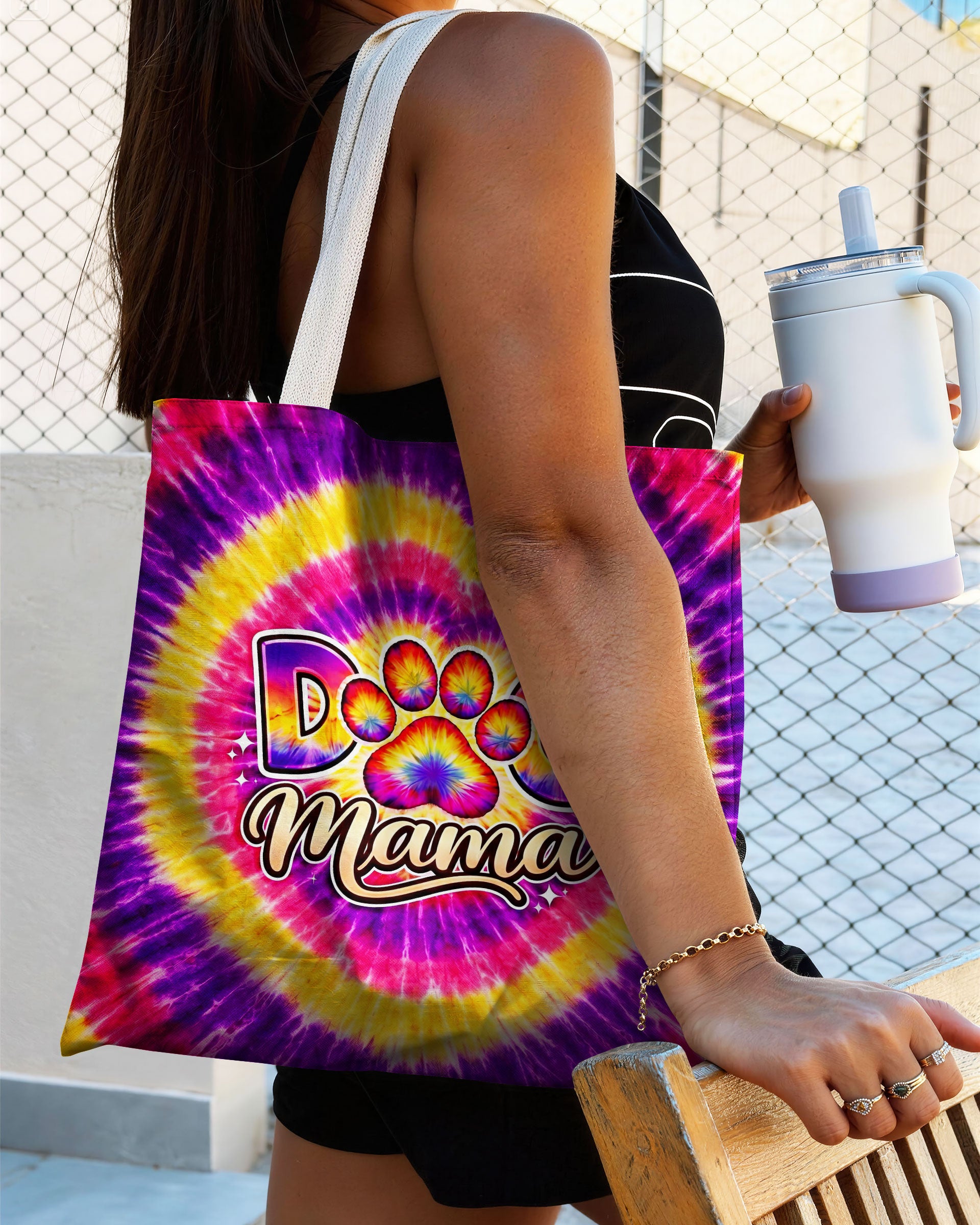 Dog Mama Paw Print Swirl Tote Bag Lifestyle shot of a woman holding the dog mama paw print swirl tote bag, perfectly blending style and pet love.