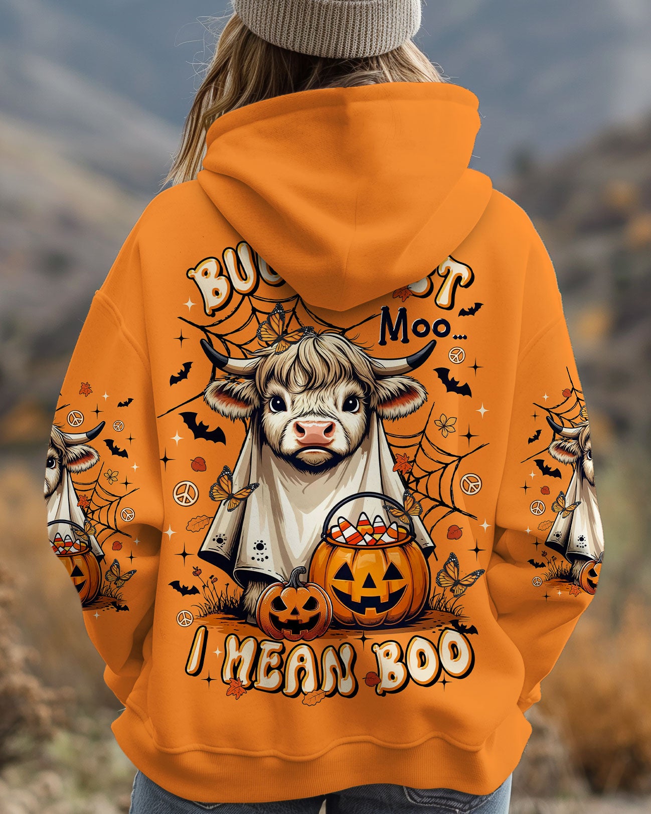 Bullsheet Moo I Mean Boo Shirt | Halloween Fun Flat lay of the Bullsheet Moo I Mean Boo shirt, displaying the vivid orange fabric and playful graphics.