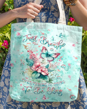 Front view of the just breathe butterfly tote bag, showcasing vibrant butterflies and floral designs in soft pastel colors.