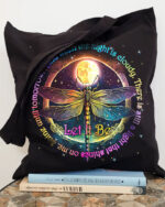 Front view of the let it be dragonfly tote bag featuring vibrant colors and detailed design on a black background.