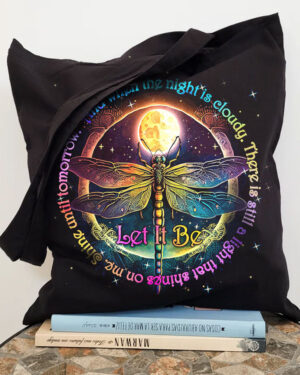 Front view of the let it be dragonfly tote bag featuring vibrant colors and detailed design on a black background.