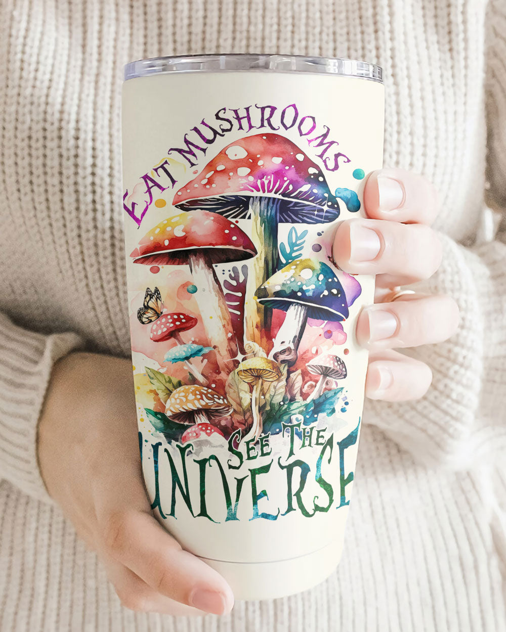 Eat Mushrooms See the Universe Insulated Tumbler Front view of the Eat Mushrooms See the Universe tumbler showcasing vibrant mushroom designs in a cozy setting.