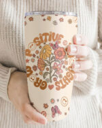 Close-up of Grow Positive Thoughts tumbler with floral design, showcasing its joyful colors and patterns.