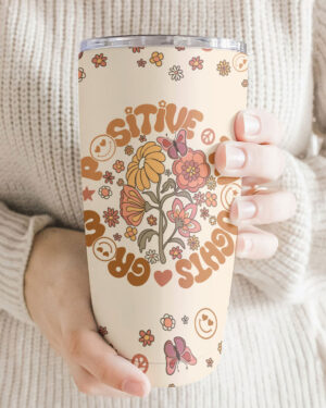 Close-up of Grow Positive Thoughts tumbler with floral design, showcasing its joyful colors and patterns.