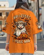 Back view of the Bullsheet Moo I Mean Boo shirt in orange, featuring a playful cow design and Halloween pumpkins.