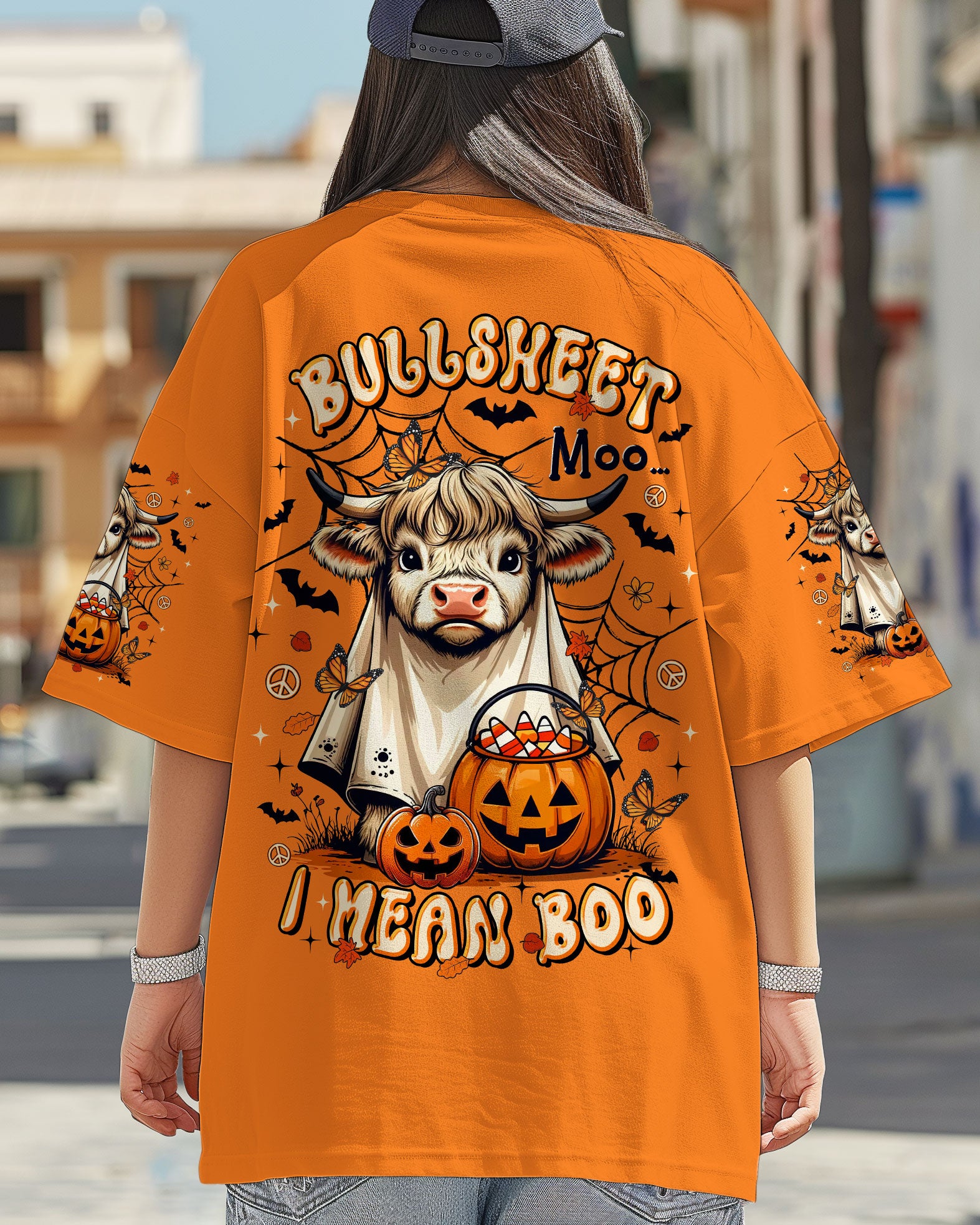 Bullsheet Moo I Mean Boo Shirt | Halloween Fun Back view of the Bullsheet Moo I Mean Boo shirt in orange, featuring a playful cow design and Halloween pumpkins.