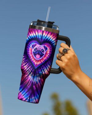 Colorful pug dog heart swirl tumbler held from the side, showcasing vibrant tie-dye design and smiling pug face.