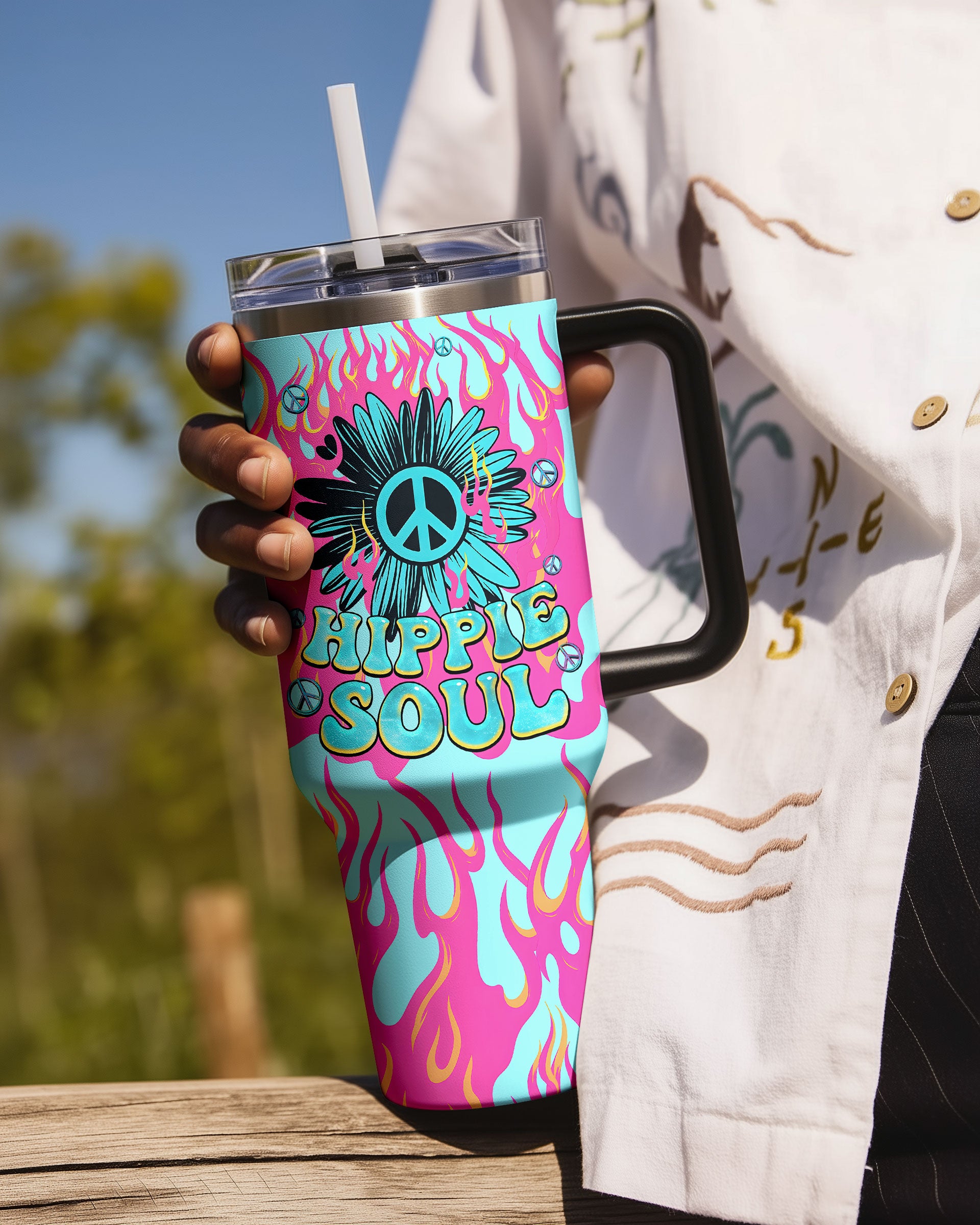 Hippie Soul Flower Tumbler | Vibrant Peace Sign Design Hippie soul flower tumbler in vibrant colors, featuring a peace sign and floral design, held in a person's hand.