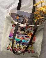 Front view of the a little hippie a little hood tote bag featuring a colorful VW bus and floral designs.