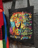Front view of the LIVE WITH A SPIRIT adventure tote bag featuring vibrant tie-dye design and floral graphics.