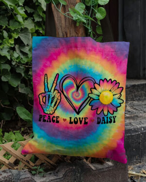 Front view of the peace love daisy tote bag featuring a colorful tie-dye design and vibrant graphics.