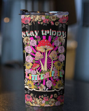 Stay trippy little hippie tumbler featuring vibrant mushrooms and flowers, shown from the front on a dark surface.