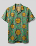 Front view of the sunshine hippie camp shirt featuring vibrant sun and floral patterns on a green backdrop.