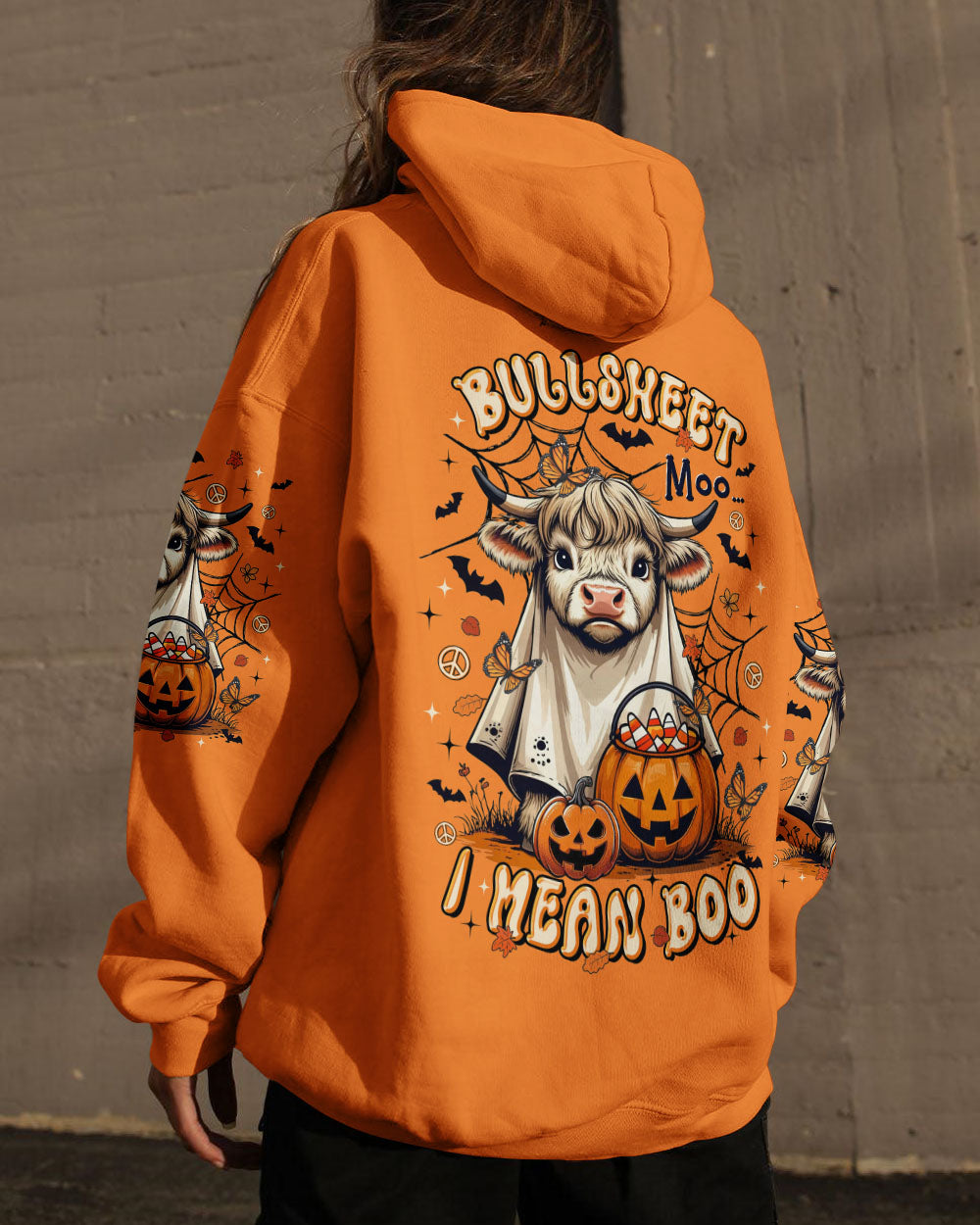 Bullsheet Moo I Mean Boo Shirt | Halloween Fun Detailed view of the Bullsheet Moo I Mean Boo shirt’s sleeves, featuring Halloween-themed illustrations.