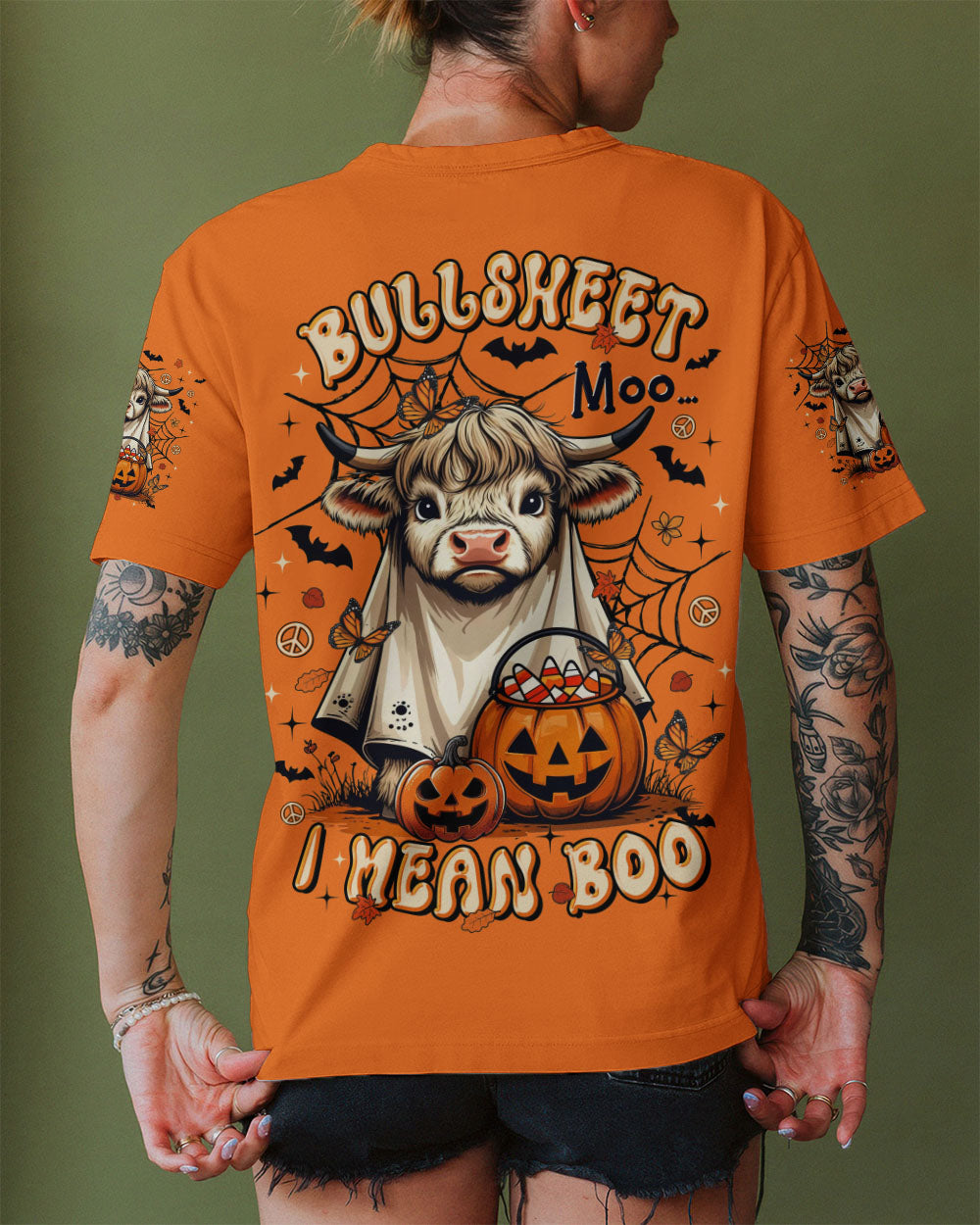 Bullsheet Moo I Mean Boo Shirt | Halloween Fun Lifestyle shot of a person wearing the Bullsheet Moo I Mean Boo shirt in a festive Halloween setting.
