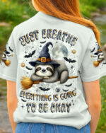 Just breathe sloth witch shirt featuring a playful sloth design in grey, viewed from the back in a natural setting.