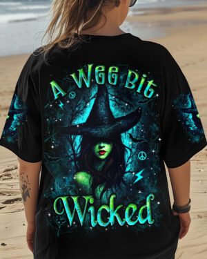 Front view of a black tee featuring 'A Wee Bit Wicked Halloween' with vivid witch design.