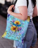 Close-up of the JUST BREATHE DRAGONFLY TOTE BAG featuring vibrant colors and floral designs.