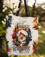 Front view of the 'Not All Who Wander Are Lost' tote bag featuring a colorful mountain and forest design.