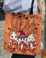 Front view of the hey boo Halloween tote bag featuring cute ghosts and vibrant orange color.