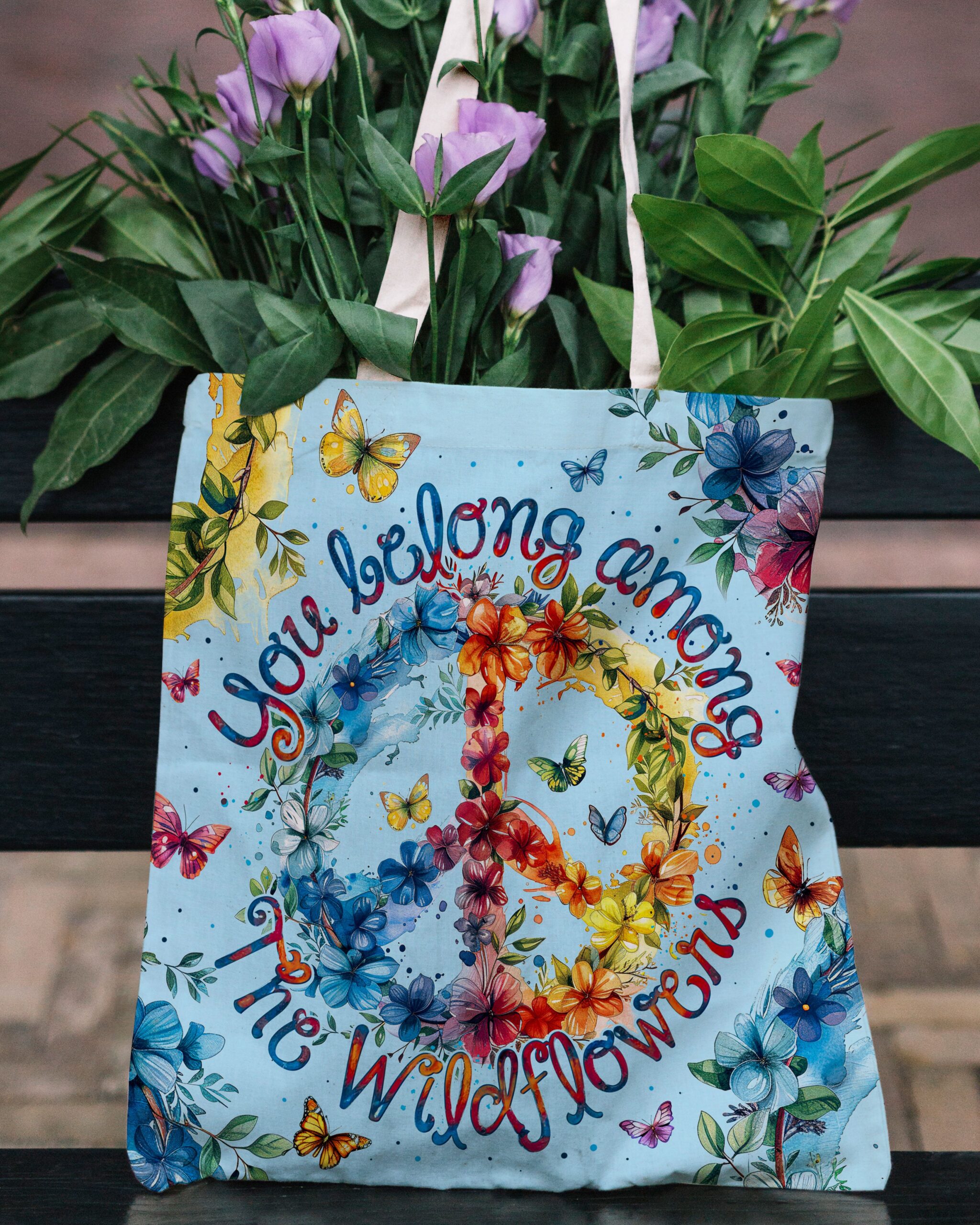You Belong Among the Wildflowers Tote Bag Lifestyle shot of the YOU BELONG AMONG THE WILDFLOWERS TOTE BAG being carried, showcasing its colorful details.