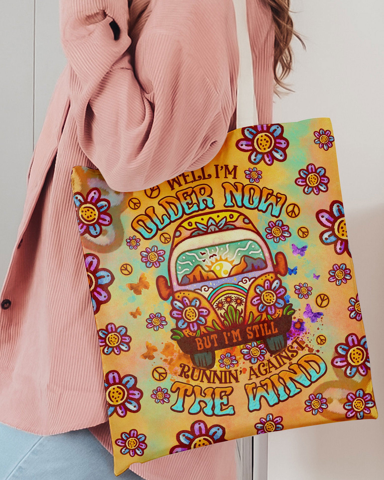 Older Now Running Against The Wind Tote Bag Lifestyle shot of the older now running against the wind tote bag held by a person, showcasing its fun design and texture.