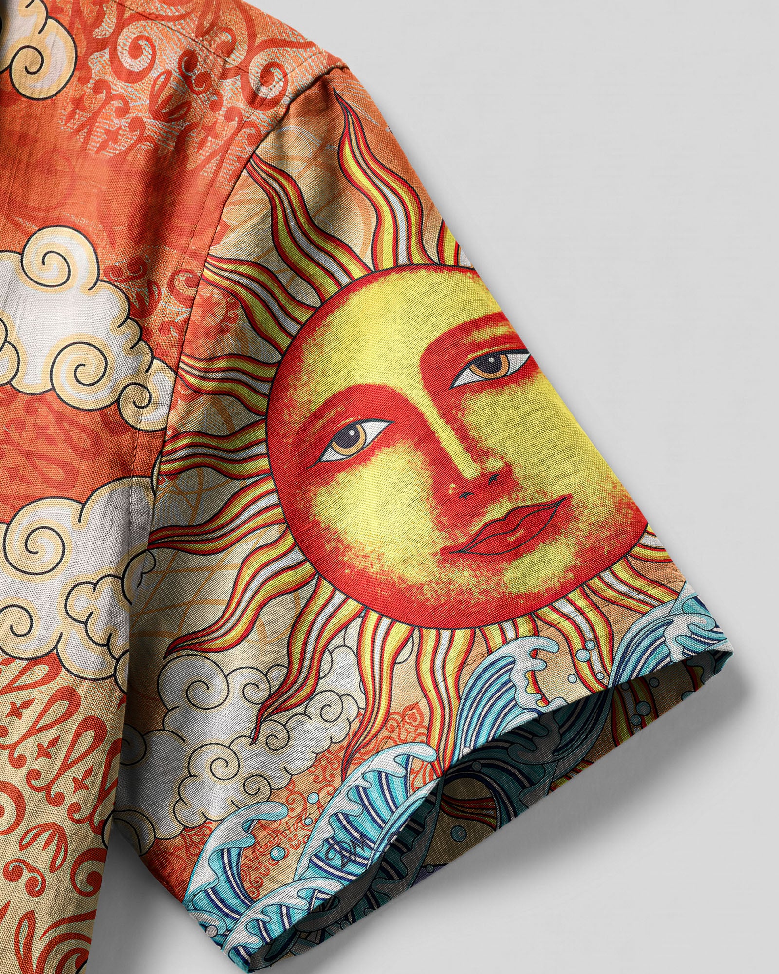 Sun and Moon Beach Hawaiian Shirt Lifestyle shot of the sun and moon beach camp shirt worn at the beach, with sunny skies and ocean waves in the background.