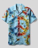 Front view of the peace symbol floral camp shirt, featuring vibrant colors and floral designs on a light blue background.